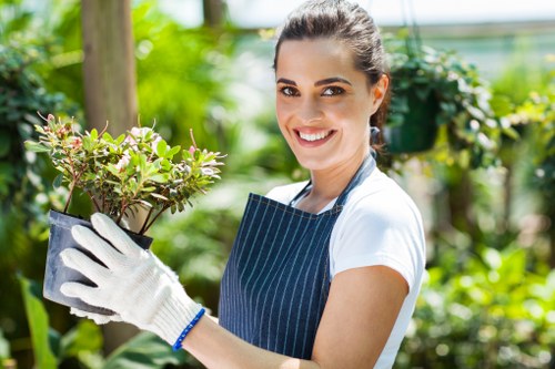 Gardening operative receiving training in equipment use